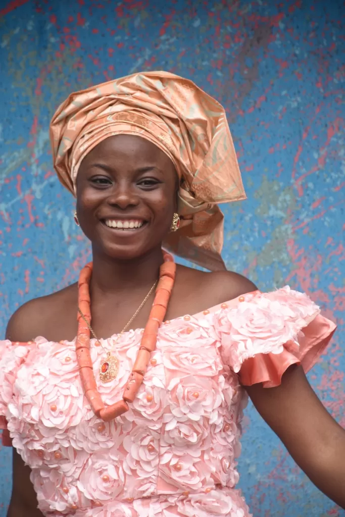 smiling woman in pink and white floral dress