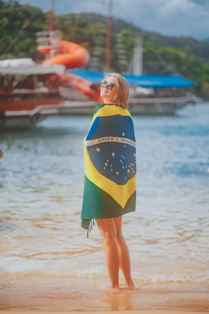 woman in blue and yellow dress standing on beach during daytime